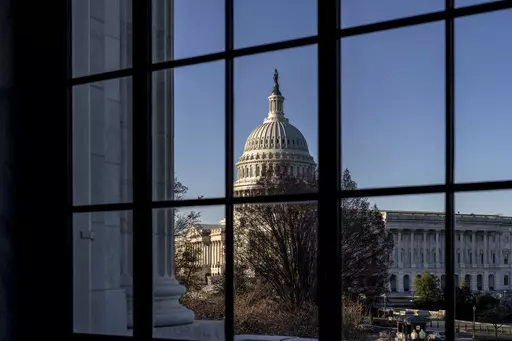 The Capitol is seen through a window in the Russell Senate Office Building as policymakers wrestle with fallout from the failure of Silicon Valley Bank, in Washington, March 15, 2023. While President Joe Biden called Monday on Congress to strengthen the rules for banks to prevent future failures, lawmakers are divided on whether any legislation is needed. (AP Photo/J. Scott Applewhite, File)