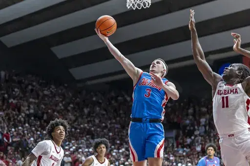 Mississippi guard Sean Pedulla (3) gets past Alabama center Clifford Omoruyi (11) for a score during the first half of an NCAA college basketball game, Tuesday, Jan. 14, 2025, in Tuscaloosa, Ala. (AP Photo/Vasha Hunt)