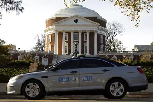 A Virginia State Police vehicle drives past the University of Virginia  Rotunda on Monday, Nov. 14, 2022, in Charlottesville, Va. Police have captured a University of Virginia student suspected of fatally shooting three members of the school’s football team on Sunday, as they returned to campus from a field trip. Two other students were wounded. (Mike Kropf/The Daily Progress via AP)