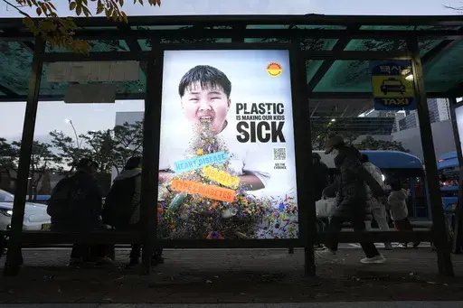 A display board shows a call for a reduction in plastic production during the fifth session of the Intergovernmental Negotiating Committee on Plastic Pollution, at a taxi station in Busan, South Korea, Saturday, Nov. 30, 2024. (AP Photo/Ahn Young-joon)
