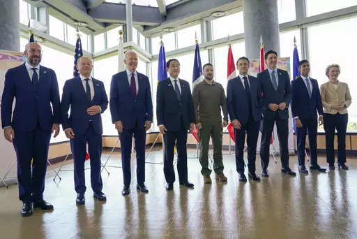 President Joe Biden, third from left, and Ukrainian President Volodymyr Zelenskyy, center, and other G7 leaders pose for a photo before a working session on Ukraine during the G7 Summit in Hiroshima, Japan, Sunday, May 21, 2023. Other leaders from right to left, European Commission President Ursula von der Leyen, Britain's Prime Minister Rishi Sunak, Canada's Prime Minister Justin Trudeau, France's President Emmanuel Macron, Zelenskyy, Japan's Prime Minister Fumio Kishida, Biden, German Chancell