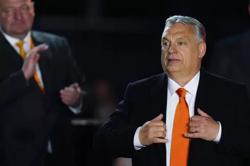Hungary's Prime Minister Viktor Orban acknowledges cheering supporters during an election night rally in Budapest, Hungary, Sunday, April 3, 2022. Early partial results in Hungary's national election are showing a strong lead for the right-wing party of pro-Putin nationalist Orban as he seeks a fourth consecutive term. (AP Photo/Petr David Josek)