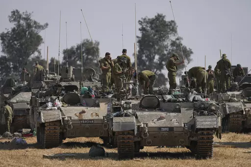 Israeli soldiers are seen at a staging ground near the border with the Gaza Strip, in southern Israel, Tuesday, April 30, 2024. (AP Photo/Tsafrir Abayov)