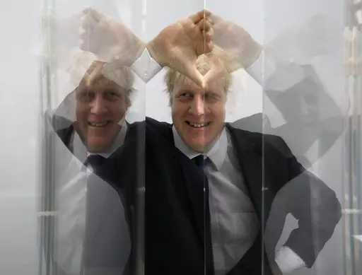 Boris Johnson, then Mayor of London looks through perspex as models of the next two commissions that will appear on the fourth plinth in Trafalgar Square are unveiled, in London, Friday, Jan. 14, 2011. He was the mayor who reveled in the glory of hosting the 2012 London Olympics, and the man who led the Conservatives to a whopping election victory on the back of his mission to “get Brexit done.” But Boris Johnson’s time as prime minister was marred by his handling of the coronavirus pandem