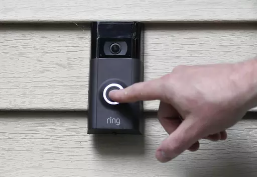 A person pushes the doorbell on his Ring doorbell camera, July 16, 2019, at his home in Wolcott, Conn. The Federal Trade Commission is sending $5.6 million in refunds to consumers as part of a settlement with Amazon-owned Ring, which was charged with failing to protect private video footage from outside access. (AP Photo/Jessica Hill, File)