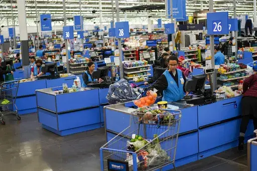 Cashiers process purchases at a Walmart Supercenter in North Bergen, N.J., on Feb. 9, 2023. Retailers, including Walmart and Target, are stepping up discounting heading into the summer of 2024, as they hope to offer frustrated shoppers some relief from higher prices and entice them to open their wallets.(AP Photo/Eduardo Munoz Alvarez, File)
