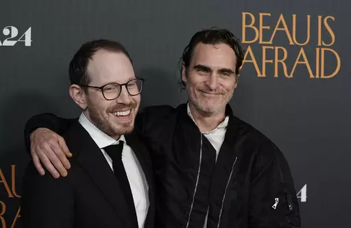 Ari Aster, left, writer/director of "Beau Is Afraid," and star Joaquin Phoenix pose together at the premiere of the film, Monday, April 10, 2023, at the Directors Guild of America in Los Angeles. (AP Photo/Chris Pizzello)