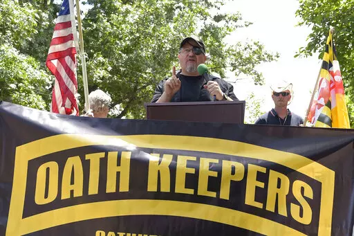 Stewart Rhodes, founder of the Oath Keepers, center, speaks during a rally outside the White House in Washington, June 25, 2017. Hundreds of pages of court documents in the case against Rhodes and four co-defendants, whose trial opens with jury selection Tuesday, Sept. 27, 2022, in Washington's federal court, paint a picture of a group so determined to overturn Biden's election that some members were prepared to lose their lives to do so. (AP Photo/Susan Walsh, File)