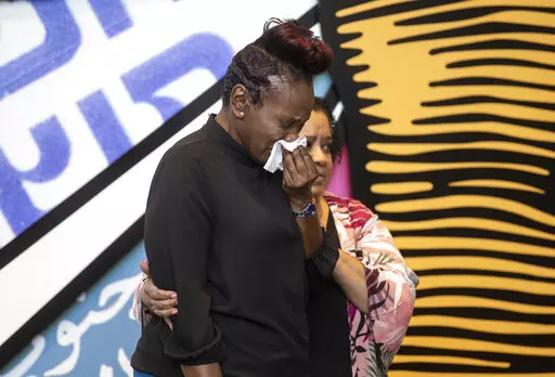 Wanda Cooper-Jones, the mother of Ahmaud Arbery, sobs as she approaches a podium at the Center for Civil and Human Rights on Wednesday, Feb. 23, 2022, in Atlanta. February 23 was declared Ahmaud Arbery Day in Georgia, in honor of the Black man who was shot and killed in 2020 in Brunswick, Ga. (AP Photo/Ron Harris)