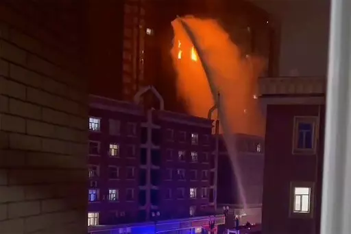 In this image taken from video, firefighters spray water on a fire at a residential building in Urumqi in western China's Xinjiang Uyghur Autonomous Region, Thursday, Nov. 24, 2022. A fire in an apartment building in northwestern China's Xinjiang region has killed several people and injured others, authorities said Friday, in the second major fire accident in the country this week. (AP Photo)