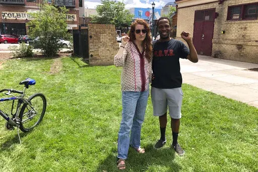 Maryah Lauer and Chauncy Johnson pose for a photo in Colorado Springs, Colo., shortly after interrupting a rally featuring Sen. Michael Bennet, D-Colo., on June 29, 2022. Lauer and Johnson pressed Bennet to be more aggressive responding to the Supreme Court's ruling last month revoking the constitutional right for women to obtain an abortion. (AP Photo/Nick Riccardi)