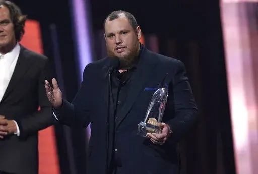 Luke Combs accepts the award for entertainer of the year during the 56th Annual CMA Awards on Wednesday, Nov. 9, 2022, at the Bridgestone Arena in Nashville, Tenn. (AP Photo/Mark Humphrey)
