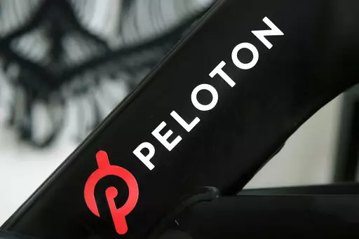 A Peloton logo is seen on the company's stationary bicycle on Nov. 19, 2019, in San Francisco. In a statement  on Wednesday, Aug. 24, 2022, Peloton announced that their high-end exercise bikes and other gear will now be available for purchase on Amazon in the U.S., a partnership aimed at boosting the fitness company's sales that have languished since the easing of pandemic lockdowns. (AP Photo/Jeff Chiu, File)