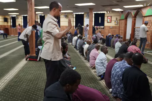 Yusuf Abdulle, standing, director of the Islamic Association of North America, prays with fellow Muslims at the Abubakar As-Saddique Islamic Center in Minneapolis on Thursday, May 12, 2022. Minneapolis will allow broadcasts of the Muslim call to prayer at all hours, Thursday, April 14, 2023, becoming the first major U.S. city to allow the announcement or “adhan” to be heard over speakers five times a day, year-round. (AP Photo/Jessie Wardarski)