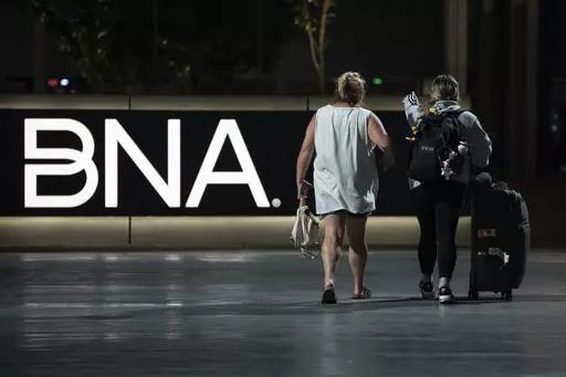 Air travelers make their way through the Nashville International Airport Tuesday, July 25, 2023 in Nashville, Tenn. A new Tennessee law that installs a state takeover of the board that oversees Nashville's airport has created confusion about who is actually running the facility. (AP Photo/George Walker IV)