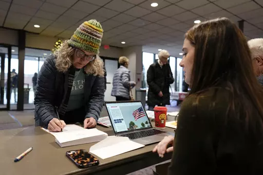 An audience member arrives at U.S. Rep. Randy Feenstra's, R-Iowa, Faith and Family with the Feenstras event, Saturday, Dec. 9, 2023, in Sioux Center, Iowa. (AP Photo/Charlie Neibergall)