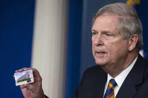 Agriculture Secretary Tom Vilsack holds up a Supplemental Nutrition Assistance Program Electronic Benefits Transfer (SNAP EBT) card during a news conference at the White House, Wednesday, May 5, 2021, in Washington. Nearly 21 million children in the U.S. and its territories are expected to receive food benefits this summer through a newly permanent federal program, the United States Department of Agriculture announced Wednesday, Jan. 10, 2024. “No child in this country should go hungry,” Vil