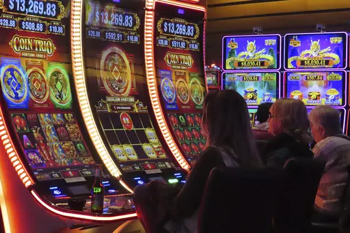 Gamblers play slot machines at the Ocean Casino Resort in Atlantic City, N.J. on Nov. 29, 2023. Figures released on Tuesday, Feb. 20, 2024, by the American Gaming Association show that the U.S. commercial casino industry had its best year ever in 2023, winning $66.5 billion from gamblers. When figures from tribal casinos are tallied later this year, the combined total is expected to approach $110 billion for 2023. (AP Photo/Wayne Parry)