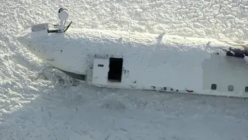 This image taken from video provided by CTV shows an aerial view of the overturned plane at Toronto Pearson Airport, Tuesday, Feb. 18, 2025. (CTV via AP)