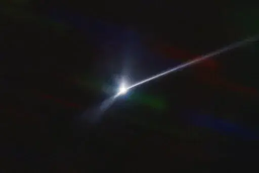 This image made available by NOIRLab shows a plume of dust and debris blasted from the surface of the asteroid Dimorphos by NASA's DART spacecraft after it impacted on Sept. 26, 2022, captured by the U.S. National Science Foundation's NOIRLab's SOAR telescope in Chile. The expanding, comet-like tail is more than 6,000 miles (10,000 kilometers) long. (Teddy Kareta, Matthew Knight/NOIRLab via AP)