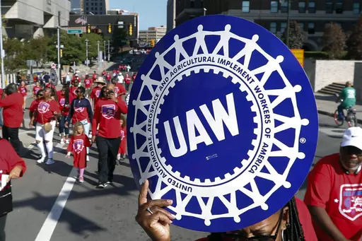 United Auto Workers members walk in the Labor Day parade in Detroit, Sept. 2, 2019. The tentative contract agreement between General Motors and the United Auto Workers union appears to be headed for defeat. The union hasn’t posted final vote totals yet, but workers at five large factories who finished voting in the past few days have turned down the four year and eight month deal by fairly large margins. (AP Photo/Paul Sancya, File)