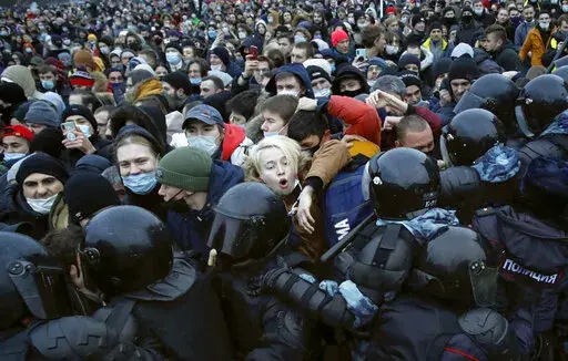People clash with police during a protest against the jailing of opposition leader Alexei Navalny in St. Petersburg, Russia, Saturday, Jan. 23, 2021. In pressure unprecedented in post-Soviet Russia, since the imprisonment of Navalny, scores of activists, independent journalists and rights advocates have been targeted with raids, detentions and designations as terrorists and foreign agents. (AP Photo/Dmitri Lovetsky, File)