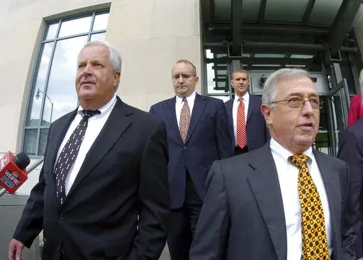 In this Tuesday, Sept., 15, 2009, file photo, former Luzerne County Court Judges Michael Conahan, front left, and Mark Ciavarella, front right, leave the United States District Courthouse in Scranton, Pa.  The two Pennsylvania judges who orchestrated a scheme to send children to for-profit jails in exchange for kickbacks were ordered to pay more than $200 million to hundreds of children who fell victim to their crimes.
U.S. District Judge Judge Christopher Conner awarded $106 million in compens