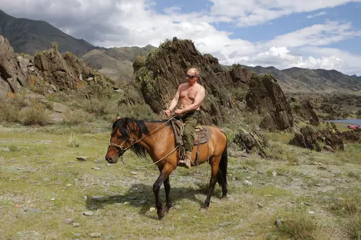 Then Russian Prime Minister Vladimir Putin rides a horse while traveling in the mountains of the Siberian Tyva region (also referred to as Tuva), Russia, Aug. 3, 2009. Putin has shot back at Western leaders who mocked his athletic exploits, saying they would look “disgusting” if they tried to emulate his bare-torso appearances. Putin made the comment during a visit to Turkmenistan early Thursday, June 30, 2022 when asked about Western leaders joking about him at the G-7 summit. (Alexei Druzh