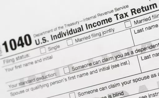 A portion of the 1040 U.S. Individual Income Tax Return form is shown July 24, 2018, in New York. The IRS has been tasked with looking into how to create a government-operated electronic free-file tax return system for all. Congress has directed the IRS to report in on how such a system might work. (AP Photo/Mark Lennihan, File)