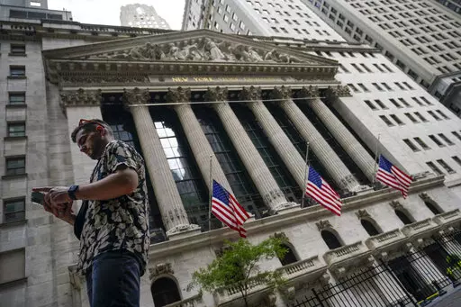 Pedestrians walk past the New York Stock Exchange, on July 8, 2022, in New York.  Stocks rose on Wall Street, Friday, Sept. 9, keeping the market on a track to break a three-week losing streak.  (AP Photo/John Minchillo, file)