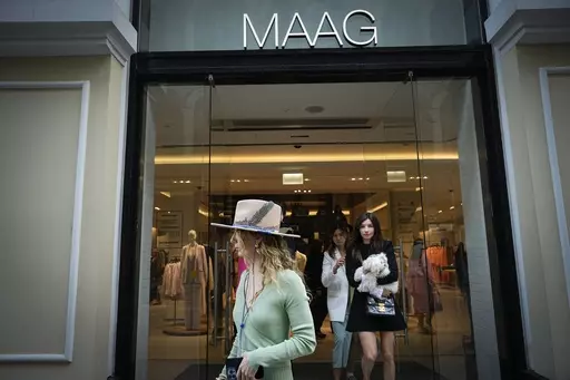 A woman exits a newly opened Maag store, a former Zara flagship store, in Moscow, Russia, Thursday, April 27, 2023. When Russia invaded Ukraine, companies were quick to respond, some announcing they would get out of Russia immediately, others vowed to curtail sales and new investment. More than a year later, it’s clear: Leaving Russia isn't as easy as the first announcements might have made it seem. (AP Photo/Alexander Zemlianichenko, File)