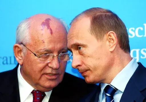 Russia's President Vladimir Putin, right, talks with former Soviet President Mikhail Gorbachev at the start of a news conference at the Castle of Gottorf in Schleswig, northern Germany, Tuesday, Dec. 21, 2004. One stood for freedom, openness, peace and closer ties with the outside world. The other is jailing critics, muzzling journalists, pushing his country deeper into isolation and waging Europe's bloodiest conflict since World War II. Such are history's bookends between Mikhail Gorbachev, the