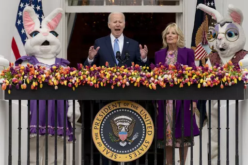 President Joe Biden, accompanied by first lady Jill Biden and Easter Bunnies, speaks on the Blue Room balcony at the White House during the White House Easter Egg Roll, April 18, 2022, in Washington. (AP Photo/Andrew Harnik, File)