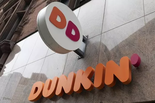 The Dunkin' logo is seen on a storefront, Friday, Oct. 14, 2022, in Boston. Reward programs have long been a way for brands to build loyalty and incentivize spending. But now some companies are becoming a bit more stingy, and customers are taking notice. Last fall, for example, many balked at Dunkin's decision to stop offering a free drink on their birthday and instead give them triple loyalty points on their purchase. (AP Photo/Michael Dwyer, File)