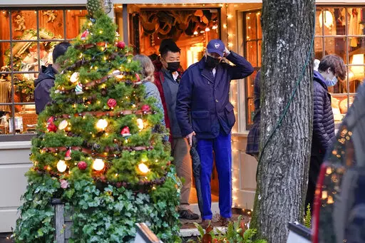 President Joe Biden walks out of a shop as he visits Nantucket, Mass., with family Friday, Nov. 26, 2021. (AP Photo/Carolyn Kaster)