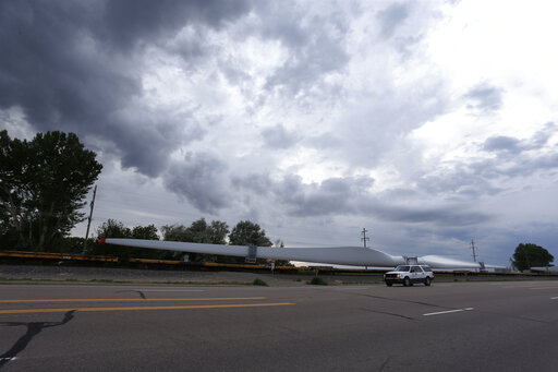 In this June 30, 2016, file photo, a train carries blades for wind turbines bound for another state through Rocky Ford, Colo., in Otero County. Both Rocky Ford, Colo., and Dawson, Ga., were classified as urban areas after the 2010 census because they had populations over 2,500 residents. Under new criteria posted this spring by the U.S. Census Bureau, these communities would no longer be designated as urban. The new criteria require places to have 2,000 housing units, which is equivalent to 5,00