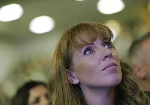 Labour deputy leader Angela Rayner watches as the leader of the British Labour Party Keir Starmer makes his keynote speech at the annual party conference in Brighton, England, Wednesday, Sept. 29, 2021.  Women from across British politics called Monday, April 25, 2022 for action to tackle misogyny after a newspaper ran a story accusing the deputy opposition leader of trying to “distract” the prime minister during debates by crossing and uncrossing her legs. (AP Photo/Alastair Grant, File)