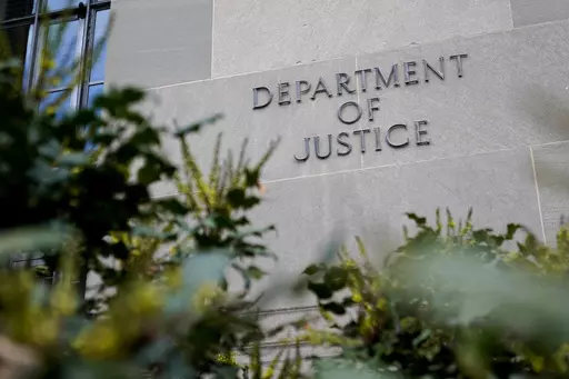 A sign marks an entrance to the Robert F. Kennedy Department of Justice Building in Washington, Jan. 23, 2023. The Justice Department proposed changes Monday, Feb. 5, 2024, to rules governing state-run programs that provide financial assistance to violent crime victims in order to address racial disparities and curb the number of subjective denials of compensation. (AP Photo/Patrick Semansky, File)