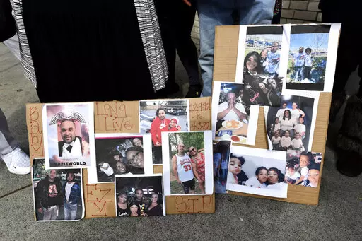 Photographs of De'vazia Turner are on display as his mother Penelope Scott speaks to the media during an interview at the corner of 10th and K street in Sacramento, Calif., on Monday, April 4, 2022. Turner was shot and killed after a shooting broke out early Sunday morning. Multiple people were killed and injured in the shooting.  (Jose Carlos Fajardo/Bay Area News Group via AP)