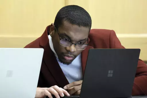 Shooting suspect Michael Boatwright looks at his attorney's computer at the defense table on the fourth day of jury deliberations in the XXXTentacion murder trial at the Broward County Courthouse in Fort Lauderdale, Fla., Monday, March 13, 2023. Emerging rapper XXXTentacion, born Jahseh Onfroy, 20, was killed during a robbery outside of Riva Motorsports in Pompano Beach in 2018, allegedly by defendants Boatwright, Trayvon Newsome, and Dedrick Williams. (Amy Beth Bennett/South Florida Sun-Sentine