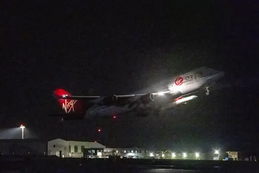 A repurposed Virgin Atlantic Boeing 747 aircraft, named Cosmic Girl, carrying Virgin Orbit's LauncherOne rocket, takes off from Spaceport Cornwall at Cornwall Airport, Newquay, England, Monday, Jan. 9, 2023. The plane will carry the rocket to 35,000 feet where it will be released over the Atlantic Ocean to the south of Ireland, as part of the Start Me Up mission and the first rocket launch from U.K. The rocket will take multiple small satellites, with a variety of civil and defence applications,