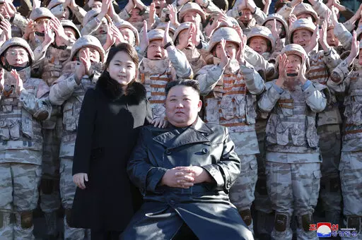 This undated photo provided on Nov. 27, 2022, by the North Korean government shows North Korean leader Kim Jong Un, center right, and his daughter, center left, with soldiers, pose for a photo,  following the launch of what it says a Hwasong-17 intercontinental ballistic missile, at an unidentified location in North Korea. Independent journalists were not given access to cover the event depicted in this image distributed by the North Korean government. The content of this image is as provided an