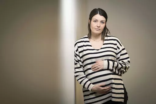 Jillaine St.Michel stands for a portrait in Boise, Idaho on Saturday, Dec. 2, 2023. A year earlier, she learned that her previous 20-week fetus had multiple genetic and developmental problems and probably wouldn’t survive. She lives in Idaho, which has a ban on abortions, so St.Michel and her husband called about 15 out-of-state clinics, finally getting on a three-week waiting list in Denver and a two-week waiting list in Seattle. Pregnant again, she is due to give birth to a boy in January. (