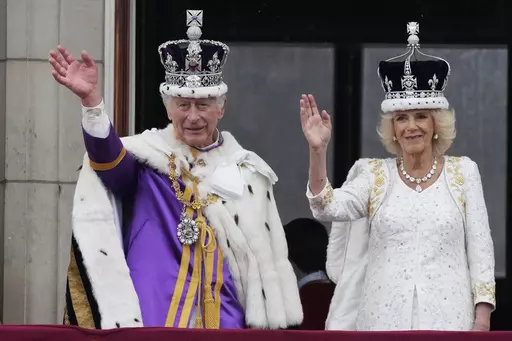 Britain's King Charles III and Queen Camilla wave to the crowds from the balcony of Buckingham Palace after the coronation ceremony in London, Saturday, May 6, 2023. (AP Photo/Frank Augstein)