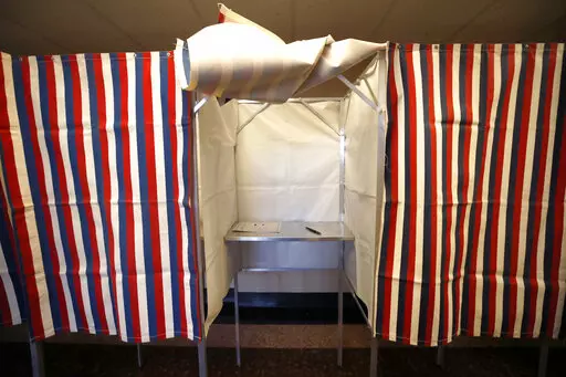 A booth is ready for a voter, Feb. 24, 2020, at City Hall in Cambridge, Mass., on the first morning of early voting in the state. U.S. intelligence officials think Russian President Vladimir Putin may use the Biden administration’s support for Ukraine as a pretext to order a new interference campaign in American politics. That's according to a new assessment described to The Associated Press by several people who spoke on condition of anonymity. (AP Photo/Elise Amendola, File)