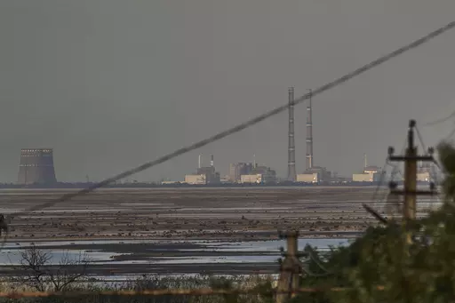 The Zaporizhzhia nuclear power plant, Europe's largest, is seen in the background of the shallow Kakhovka Reservoir after the dam collapse, in Energodar, Russian-occupied Ukraine, Tuesday, June 27, 2023. Officials at the Russian-controlled Zaporizhzhia Nuclear Power Plant said that the site was attacked Sunday April 7, 2024, by Ukrainian military drones, including a strike on the dome of the plant’s sixth power unit. (AP Photo/Libkos, File)
