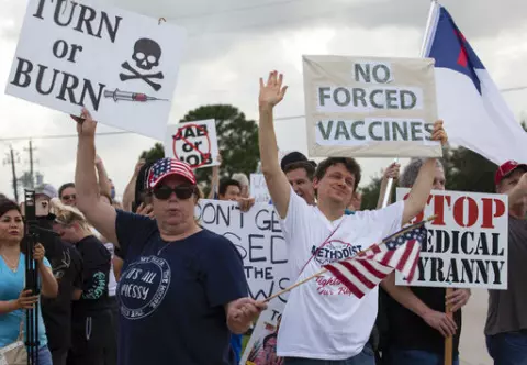 In this June 7, 2021, photo, demonstrators at Houston Methodist Baytown Hospital in Baytown, Texas, wave at cars that honk at them to support their protest against a policy that says hospital employees must get vaccinated against COVID-19 or lose their jobs. Religious exemptions are increasingly becoming a workaround for hospital and nursing home staff who want to keep their jobs in the face of federal COVID-19 vaccine mandates that are going into effect nationwide this week. (Yi-Chin Lee/Housto