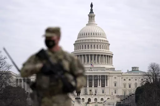 A member of the National Guard patrols the area outside of the U.S. Capitol at the Capitol in Washington, Wednesday, Feb. 10, 2021. The House passed a defense policy bill Thursday, Dec. 14, 2023, that authorizes the biggest pay raise for troops in more than two decades, overcoming objections from some conservatives concerned the measure did not do enough to restrict the Pentagon's diversity initiatives, abortion travel policy and gender-affirming health care for transgender service members. (AP 