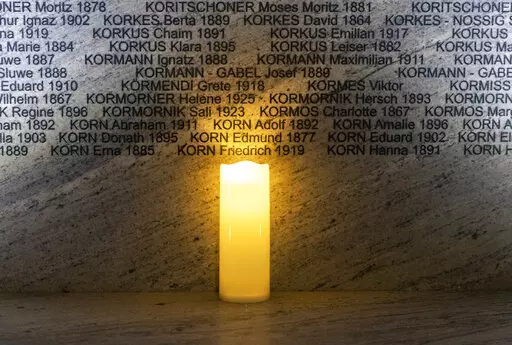 FILE -A light illuminates names at the Shoah Wall of Names Memorial during the inauguration ceremony, in Vienna, Austria, Nov. 9, 2021. Vienna born Holocaust survivor Gertrude Pressburger, who became famous during the 2016 presidential campaign in Austria with a video message in which as "Mrs. Gertrude" she warned of hatred and exclusion triggered by the far right, has died at age 94. (AP Photo/Lisa Leutner, File)