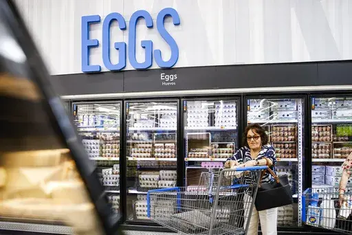 A woman buys eggs at a Walmart Superstore in Secaucus, New Jersey, on July 11, 2024. (AP Photo/Eduardo Munoz Alvarez)